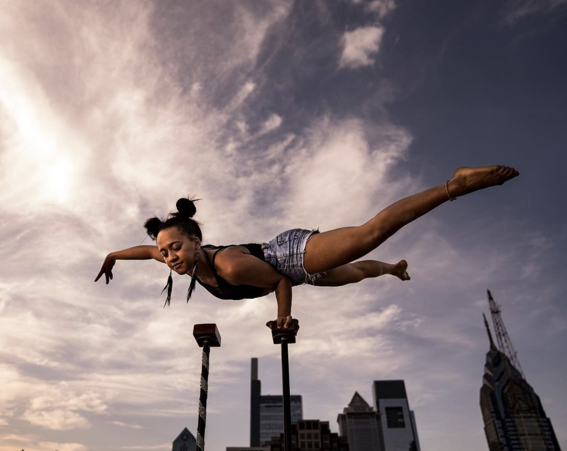 Tiffany balancing on handstand canes outdoors